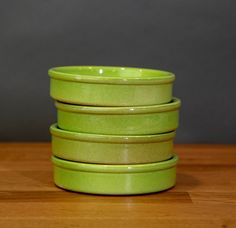 four green bowls stacked on top of each other