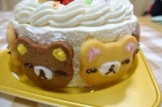 there is a cake with two cats on it and one has white frosting in the middle