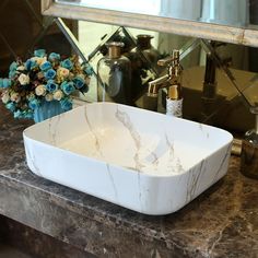 a bathroom sink sitting on top of a marble counter