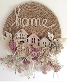 a wall hanging with flowers and the word home on it