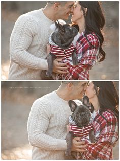 a man and woman kissing while holding a small dog in their arms, both wearing sweaters