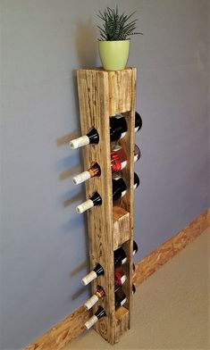 a wooden wine rack holding several bottles and a potted plant