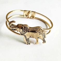 Expertly crafted by hand, this elephant cuff bracelet/bangle is a unique and stunning addition to any jewelry collection. With intricate details and quality craftsmanship, it is sure to make a statement and add a touch of elegance to any outfit. Experience the beauty and artistry of handcrafted jewelry with this stunning accessory. Gold Bohemian Bracelets, Elegant Bracelets With Unique Design As Gift, Elegant Bracelets With Unique Design For Gift, Gold Bohemian Cuff Bracelet, Elegant Bangle With Unique Design, Unique Design Cuff Bracelet Bangle As Gift, Gold Bangle Bracelet With Unique Design, Elegant Bangle Bracelets With Unique Design, Bohemian Metal Bangle Cuff Bracelet