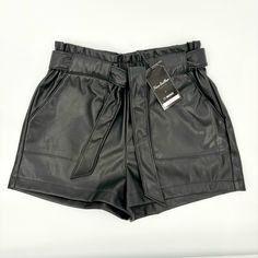 Elevate Your Style With These Sleek Black Faux Leather Shorts In Size Small. Perfect For Adding A Touch Of Edgy Sophistication To Any Outfit, These Shorts Feature A Flattering Tie Belt For A Customizable Fit. Ideal For Both Casual And Dressy Occasions. Chic Date Night Shorts For Fall, Party Faux Leather Belted Bottoms, Chic Going Out Shorts With Belt Loops, Chic Faux Leather Shorts, Paperbag Waist Bottoms With Belt Loops For Night Out, Chic Belted Shorts For Night Out, Elegant Faux Leather Bottoms For Summer, Elegant Faux Leather Summer Bottoms, Elegant Faux Leather Bottoms For Day Out