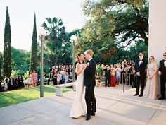 a bride and groom standing in front of an outdoor ceremony