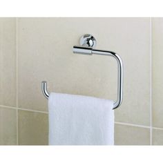 there is a towel holder on the wall in this bathroom with white tiles and tile flooring