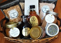 a basket filled with lots of different types of food and condiments on top of a wooden table