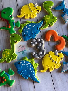 decorated cookies are arranged in the shape of dinosaurs