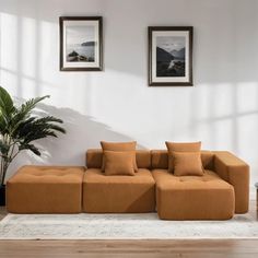 a living room with two pictures on the wall and a couch in front of it