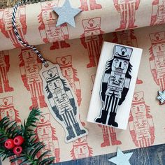 a rubber stamp with an image of a robot on it next to a christmas tree