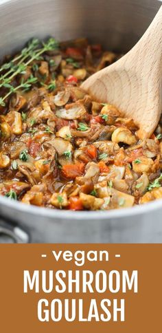 easy vegan mushroom goulash in a pot with a wooden spoon on the side