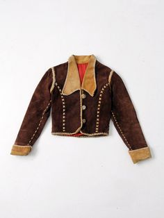 "This 1970s vintage, custom leather jacket has bold rock n' roll style. The rare find, was hand crafted and features whip-stitch and braid detailed seams. It fits cropped and fitted with slightly puffed shoulders. Dark brown suede shapes the jacket with yellow leather detailing on the big collar and rolled cuffs. Princess seams down the bust are detailed with cross-stitches. The jacket closes with 3 horn buttons, and opens to a fully lined interior. CONDITION In great condition with wear consist 70s Jacket, Style Leather Jacket, Custom Leather Jackets, Cropped Coat, 70s Outfits, Big Collar, 1970s Fashion, Yellow Leather, Dream Clothes