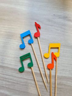 colorful music notes are on sticks with toothpicks