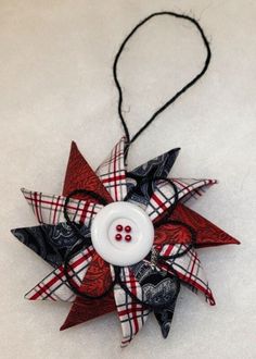 a red, white and black pinwheel ornament