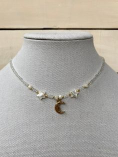 this gorgeous celestial necklace is perfect for anyone who loves the moon. Adjustable Celestial Necklace With Moon Charm, White Moon Phase Celestial Necklace, White Celestial Moon Phase Necklace, White Celestial Necklace With Moon Phase, Star Charm Necklaces With Round Beads For Jewelry Making, Celestial Moon Charm Necklace For Jewelry Making, Bohemian Necklaces With Moon Charm And Round Beads, White Celestial Necklace With Moon Charm, Handmade White Celestial Necklace