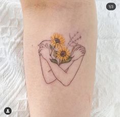 a woman with a sunflower tattoo on her arm