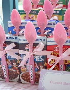 pink candy lollipops are on display in front of cereal boxes