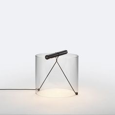 a light that is sitting on top of a white surface with a black object in the middle