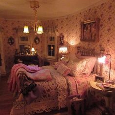 a bed room with a neatly made bed next to a table and two lamps on the wall