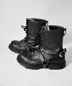 Unisex leather bootstrap harnesses. We created each garment from 100% real leather adjustable stripes and detailed with quality nickel-plated fittings. - Tera boot harnesses: adjustable in the back & in the front. - Solar shoe cuffs: thick leather stripes (2 & 3 cm width/ 0.8 & 1.2 in) with buckles and two large O-rings. You can wear MadElephant's black leather boot harness accessories with almost all of your shoes. Alternative Leather Moto Boots With Buckle Closure, Gothic Leather Combat Boots With Buckle Closure, Punk Leather Moto Boots With Protective Metal Feet, Leather Boots With Protective Metal Feet For Concerts, Harness Accessories, Shoe Decoration, Boot Straps, Leather Harness, Decorated Shoes