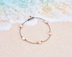 Playfully dainty, our Princess anklets are truly waterproof, unisex & perfect for any occasion. Inspired by our best-selling Princess necklaces, these are the everyday ankle bracelets that take you from the beach to the pool, and back again all summer long. (Beach and pool not necessary for carefree summer vibes!)- 5 peach pearls - oval, baroque, or rondelle, you choose! (or the details/size)- Signature hand-spun Tula Blue ROPE- 100% waterproof- Loop & puka shell closure- Standard length: 10"One Pearl Princess, Princess Necklace, Puka Shell, Versatile Jewelry, Ankle Bracelets, Long Beach, The Pool, Summer Vibes, Anklets