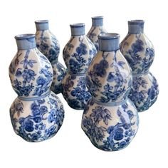 six blue and white vases sitting next to each other