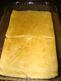 an uncooked flat bread in a glass dish