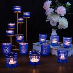 blue glass candle holders and vases on a table