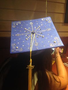 a woman wearing a graduation cap with pearls on it