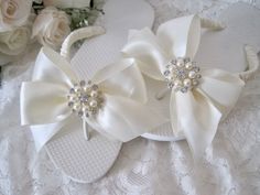 "ALL ORDERS TOTALING OVER $35 SHIP FREE PLEASE MAKE SURE YOU ARE ORDERING THE CORRECT SIZE. THESE ARE NOT RETURNABLE SINCE THEY ARE CUSTOM ORDERED AND DESIGNED IN THE SIZE YOU ORDER. Choose Flats or wedge 1/2\" flat or 1 1/2\" wedge.  I designed these gorgeous bridal flip flops with ivory cream ribbon. I French knotted around the straps and then handmade the beautiful matching bows with pearl and rhinestone brooch accent on each bow. More Bridal Flip Flops Here: https://www.etsy.com/shop/theragg Bride Flip Flops, Baby Flip Flops, Custom Flip Flops, Bridal Flip Flops, Wedding Flip Flops, Bridal Clip, Girls Flip Flops, Lapel Flower, Wedge Flip Flops