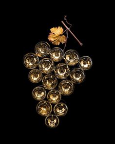 a bunch of wine glasses sitting on top of a table next to a yellow leaf