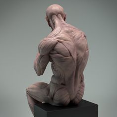 a sculpture of a man sitting on top of a black block with his back turned to the camera