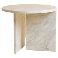 a white marble table with an oval shaped top and two curved sections on each side