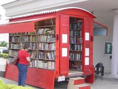 a man standing in front of a red book case