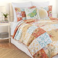 a bed with a colorful comforter and pillows