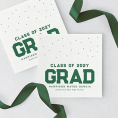 two green and white graduation cards on top of each other next to a green ribbon