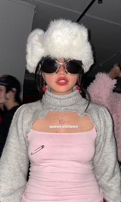 a woman wearing sunglasses and a furry hat