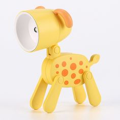 a yellow toy dog with orange spots on it's body