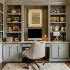 a home office with built - in bookcases and a computer desk on the far wall