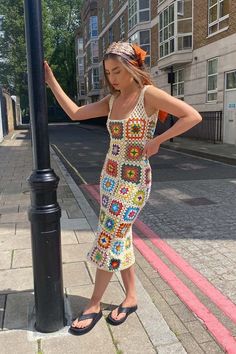 a woman standing next to a lamp post