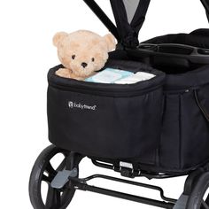 a teddy bear is sitting in a stroller