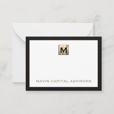 a black and white business card with the letter m in gold foil on it's front