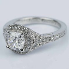 a cushion cut diamond ring with pave set shoulders