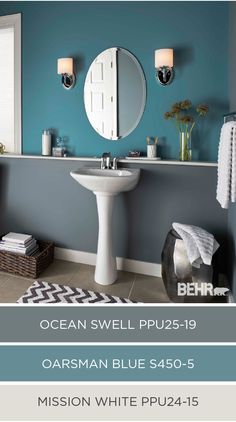 a bathroom with blue walls, white fixtures and a pedestal sink in the center of the room