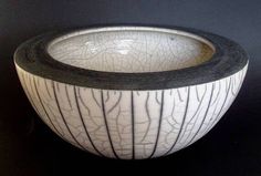 a white and black bowl sitting on top of a table