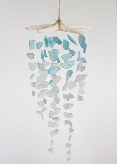 a sea glass wind chime hanging from a rope