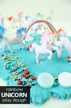 there is a cake with unicorns on it and other toys in the shape of horses