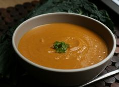 a white bowl filled with soup on top of a table