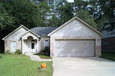 a house that is in the grass near trees