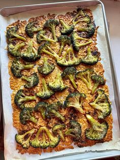 broccoli florets and cheese on top of a sheet of baking paper